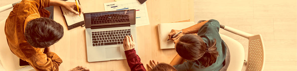 Young Asian business team work together in project brainstorm meeting, using laptop computer. Colleague coworker, startup office or people teamwork concept. Top view, banner size with copy space