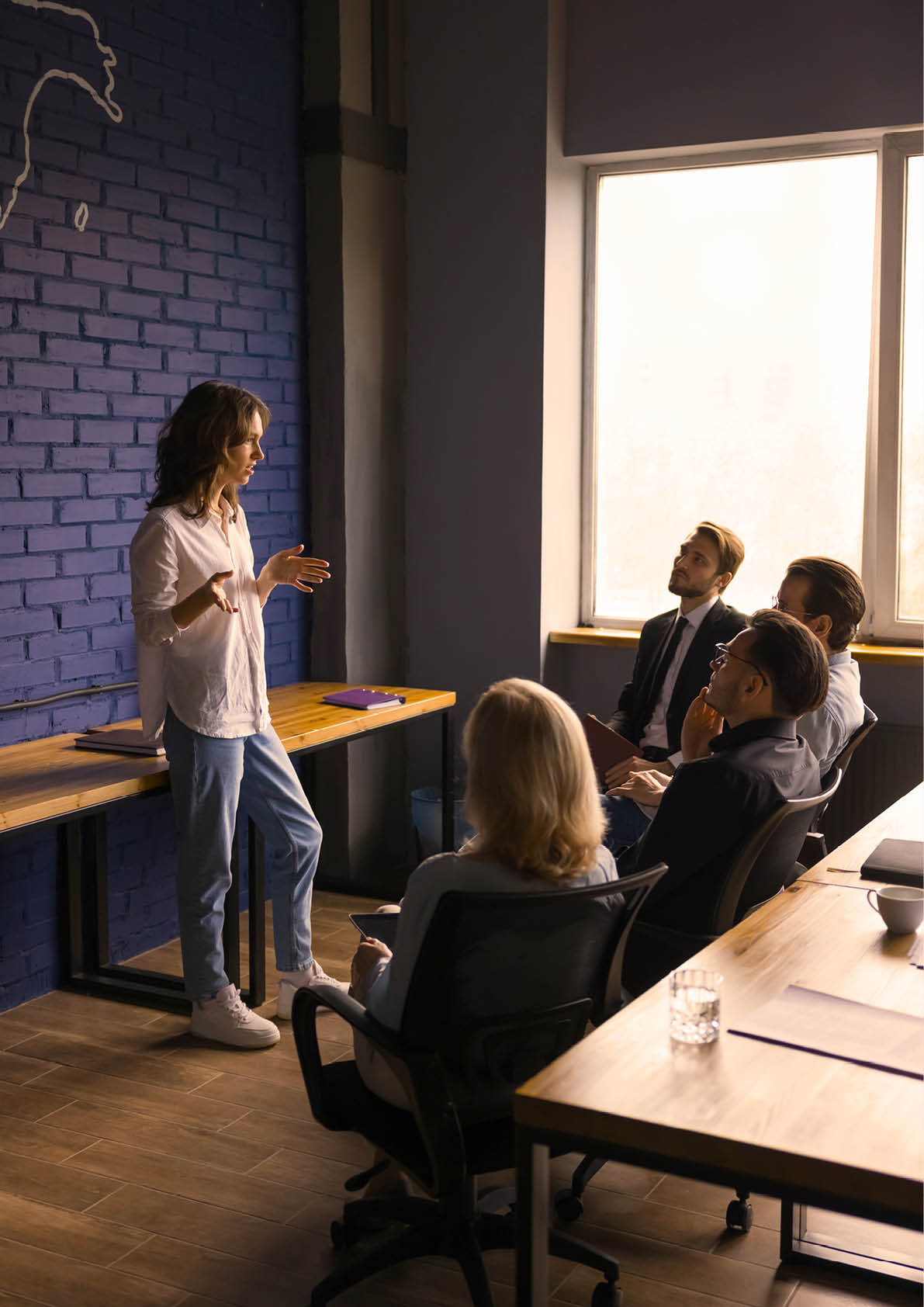 Creative business group discussing ideas for startup, brainstorming on briefing. Project manager girl presenting plan, strategy to team of colleagues on office meeting, speaking to colleagues
