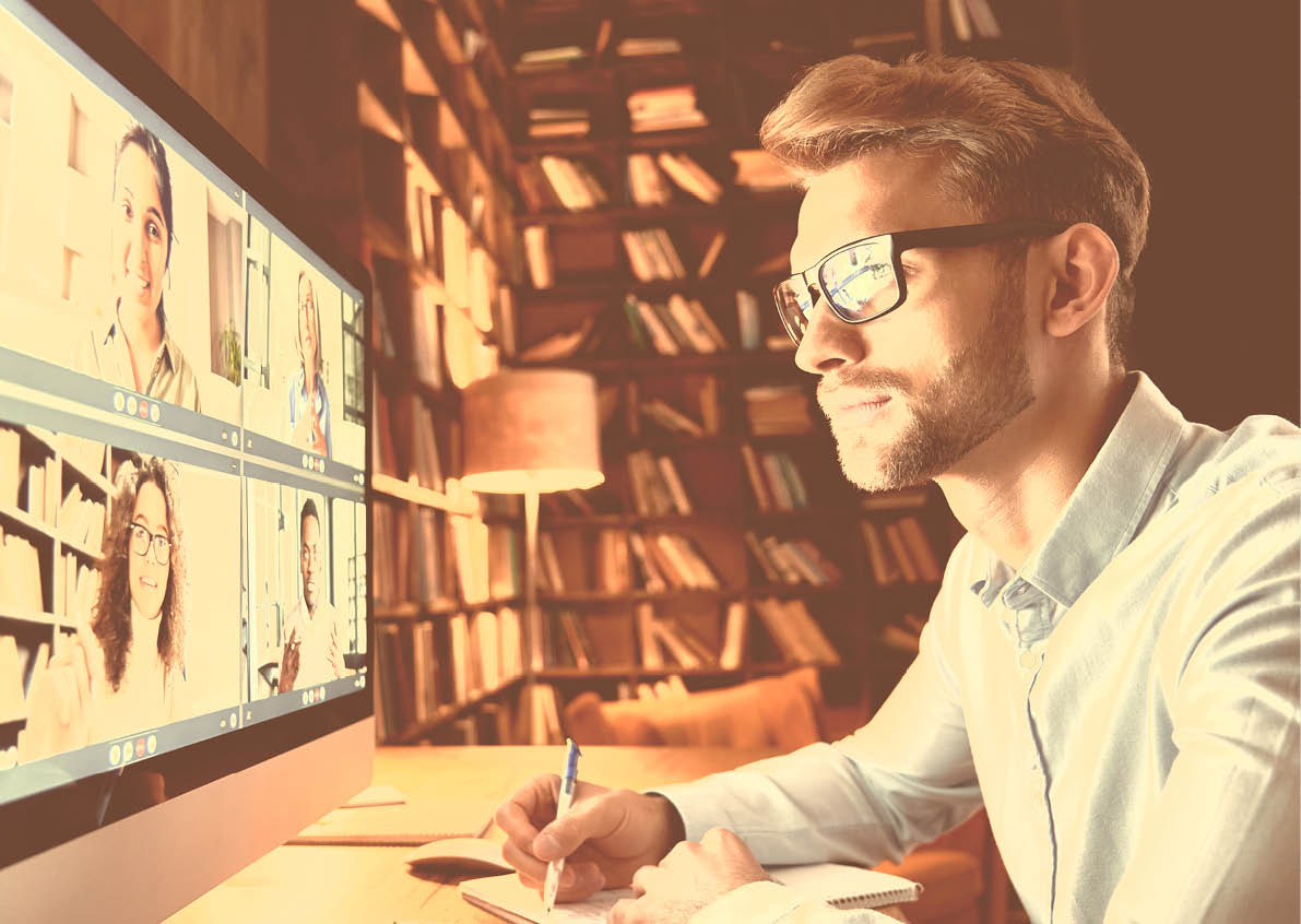 Business man having virtual team meeting on video conference call using computer. Social distance employee working from home office talking to diverse colleagues in remote videoconference online chat.