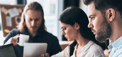 Creative office. Young modern colleagues in smart casual wear working while spending time in the office           
