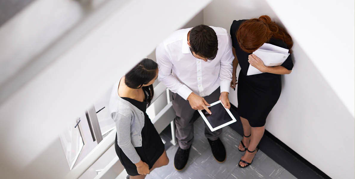 Quick brainstorm on the way to the meeting. Shot of a colleagues taking together in a stairwell