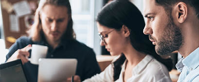 Creative office. Young modern colleagues in smart casual wear working while spending time in the office           