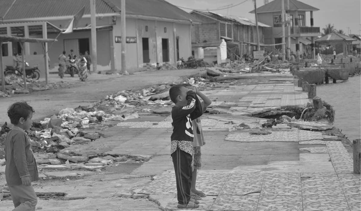 Banten, Indonesia - 28 December children playing between stranded boats and ports affected by the 2018 Banten tsunami