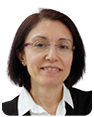 A woman wearing glasses and a black and white sweater is standing in front of a white wall. AI generated content