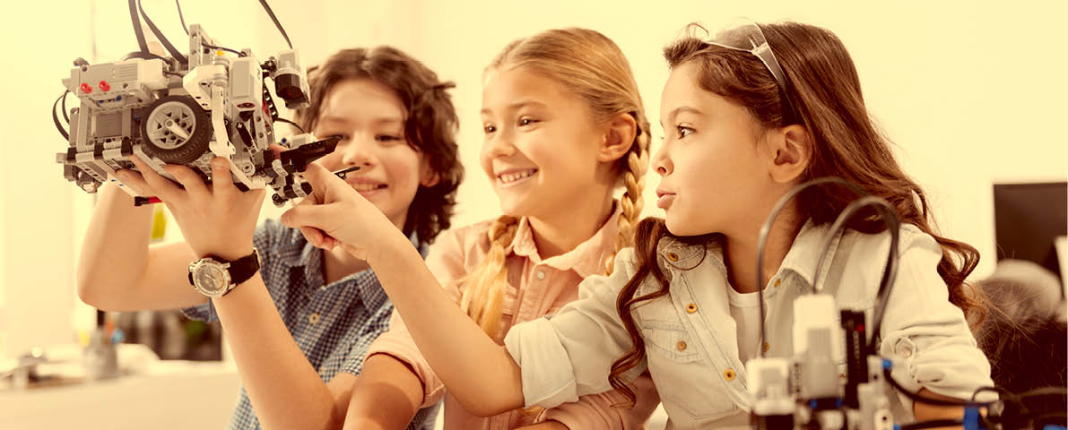 Joyful kids testing modern device at school