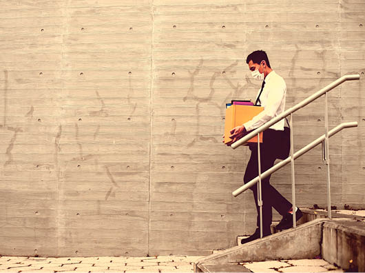 Asian business man wear face mask and he is being fired because of economic downturn due to the covid-19 spread all over the world