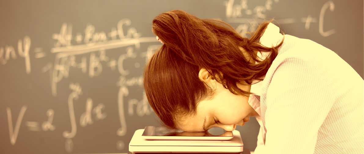 Young Woman Putting Head Down On Stack Of Electronic Device