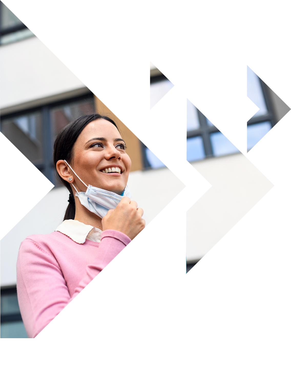 Low angle view of teacher with face mask after lockdown, walking outdoors in front of school.