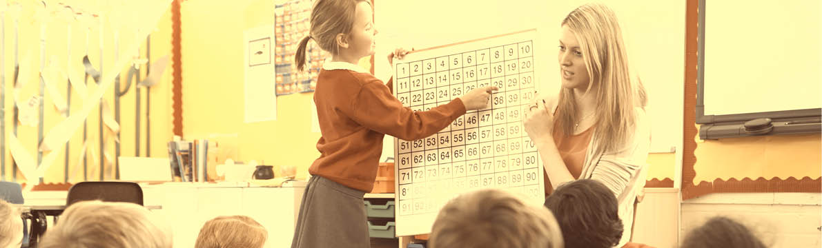 Teacher Teaching Maths To Elementary School Pupils