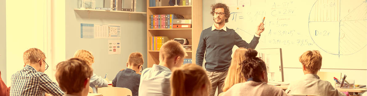 Caring Teacher Explains Lesson to a Classroom Full of Bright Diverse Children. In Elementary School with Group of Smart Multiethnic Learning Science, Listening to a Teacher with Great Interest
