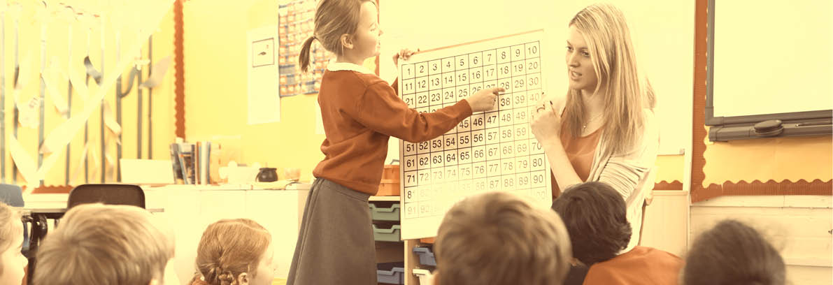 Teacher Teaching Maths To Elementary School Pupils