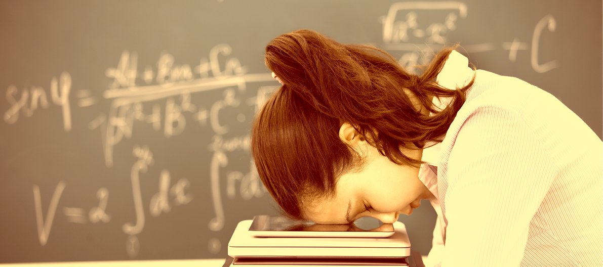 Young Woman Putting Head Down On Stack Of Electronic Device