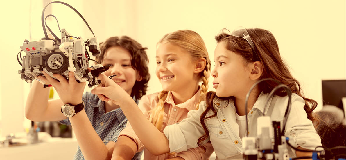 Joyful kids testing modern device at school