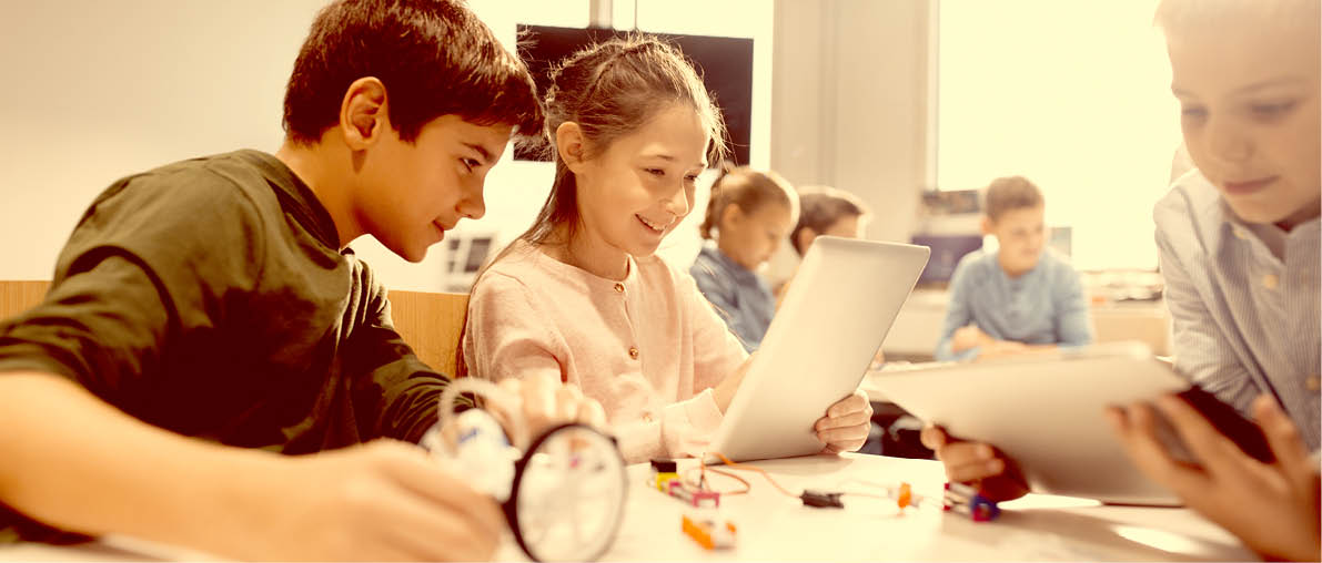 education, science, technology, children and people concept - group of happy kids or students with tablet pc computer programming electric toys and building robots at robotics school lesson